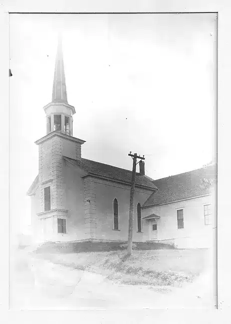 Old church building with a telephone pole in the front